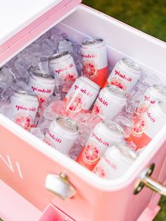 a pink cooler filled with lots of drinks