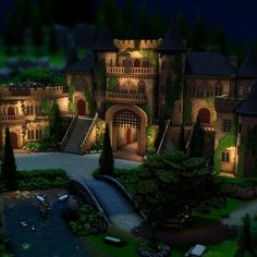 an aerial view of a castle at night with lights on and stairs leading up to it