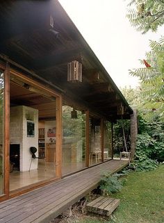 a wooden deck with a phone on top of it next to a house in the woods