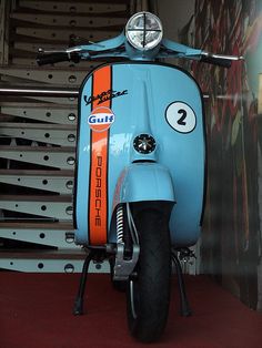 a blue scooter parked in front of a staircase