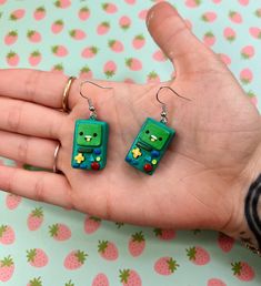 💚BMO Earrings💚  BMO is hands down clearly one of my favorite Adventure Time characters so OF COURSE, I had to make them as little earrings  Made with polymer clay, painted with acrylic paints & sealed with a glaze and attached with a stainless steel fishhook earring! 💙 Adventure Time Characters, Fish Hook Earrings, Acrylic Paints, Handmade Polymer Clay, Adventure Time, Earrings Handmade, Favorite Jewelry, Jewelry Earrings Dangle, Glaze