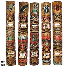 four wooden totems with different designs on them