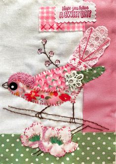 a close up of a bird on a patchwork piece of cloth with flowers and lace