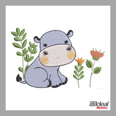 a small hippo sitting next to some flowers