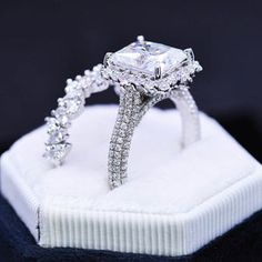 an engagement ring is displayed in a white box