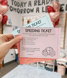 someone is holding up two tickets for the speed driving ticket contest on valentine's day