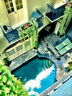 an aerial view of a house with a pool in the middle and two balconies above it