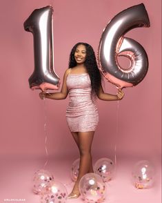 a woman holding balloons in front of her face and the number six is surrounded by bubbles