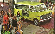 a group of people standing in front of a green van