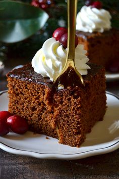 a piece of chocolate cake with whipped cream and cherries