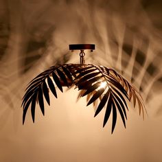 a close up of a light fixture with a plant on it's back end