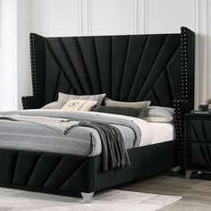 a bed with black headboard and foot board