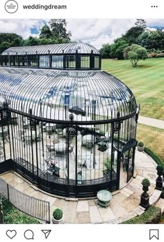 a large glass building in the middle of a park