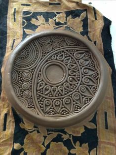 a decorative bowl sitting on top of a table