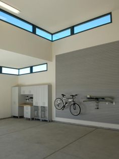 an empty garage with two bikes mounted to the wall