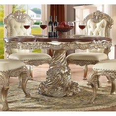 a dining room table and chairs with wine glasses on it