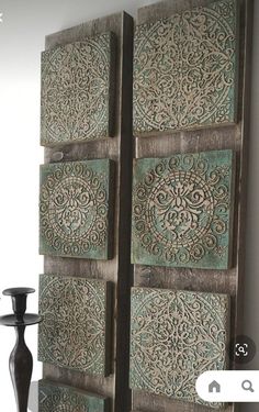 an old wooden door with intricate designs on the doors and side panels, next to candlesticks