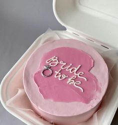 a pink cake in a white box with the word bride to be written on it