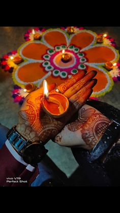 a person holding a lit candle in their hand