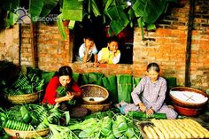 two women sitting on the ground in front of baskets full of plants