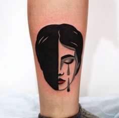 a woman's face is shown on the lower half of her leg, with black ink