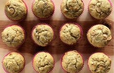 twelve muffins sitting on top of a wooden cutting board