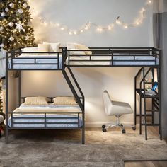 a bunk bed sitting next to a christmas tree in a room with lights on the ceiling