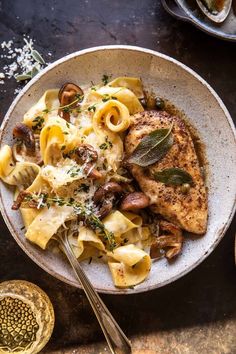 a white bowl filled with pasta and meat