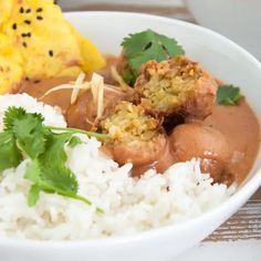 a white bowl filled with rice and meat