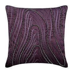 a purple pillow with beading on it