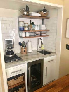 a small kitchen with open shelving above the sink