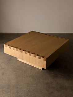 a wooden table sitting on top of a cement floor