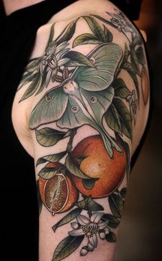 a woman's half sleeve tattoo with oranges and leaves