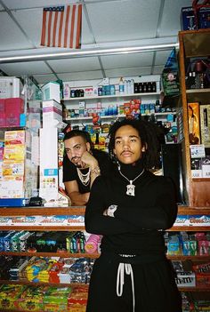 two people standing in front of a store counter