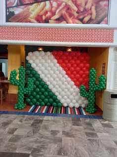 balloon art in the shape of a flag is displayed at a mexican themed restaurant,