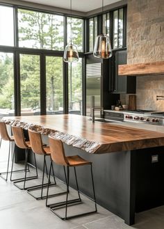 a large kitchen island with four stools in front of it and windows to the side