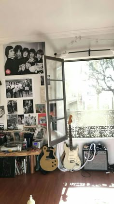 a room filled with guitars and pictures on the wall next to a window in front of it