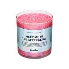 a pink candle that says meet me in the afterglow