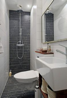 a bathroom with black and white tiles on the walls