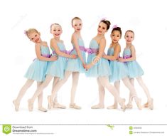 six young ballerinas in blue dresses posing for the camera with their arms around each other