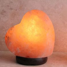 a himalayan stone heart shaped lamp on a stand