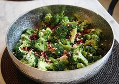 broccoli and cranberry salad in a silver bowl on a place mat