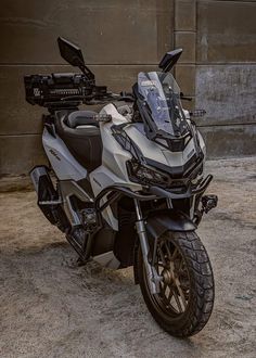 a motorcycle parked in front of a building with no one on it's seat