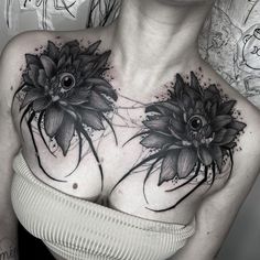 a woman's chest with black flowers on it