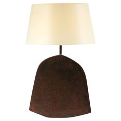 a table lamp with a white shade on it's base and a wooden base