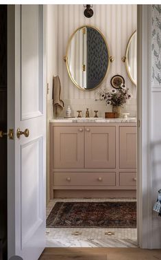 a bathroom with two round mirrors on the wall