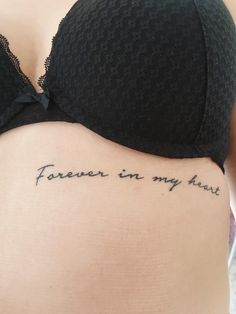 the back of a woman's stomach with words written in cursive writing