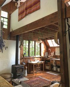 an old fashioned kitchen and living room with wood burning stove