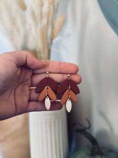 a person holding some kind of earrings in their hand