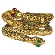 Rare Pair of Period Haute Couture Chanel Snake Bangles by Maison Goossens. These hand made hinged bracelets are composed of dozens of graduated gilt filigree caps soldered together to form the body of each bracelet. Each snake head is hand made with pate de verre cabochon eyes in emerald and ruby. Even the hinges are handmade which is quite extraordinary. The matching necklace is in the traveling show sponsored by Chanel, "Gabrielle Chanel, Manifest de Mode". 1960's Chanel Haute Couture. Signed Estate Jewelry For Sale, Snake Bangle, Chanel Gabrielle, Madame Gres, Vintage Engagement Rings Sapphire, Chanel Brooch, Snake Head, Vintage Gold Rings, Chanel Haute Couture